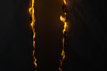burning paper, glowing edge of paper on a black backgroundの写真素材