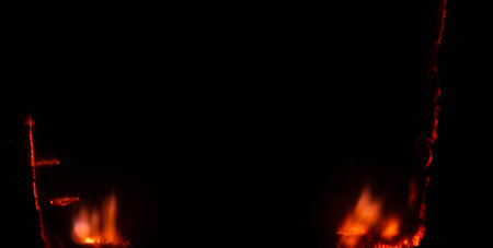 burning paper, glowing edge of paper on a black backgroundの写真素材