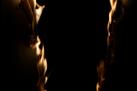 burning paper, glowing edge of paper on a black backgroundの写真素材