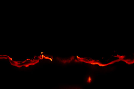 burning paper, glowing edge of paper on a black background
