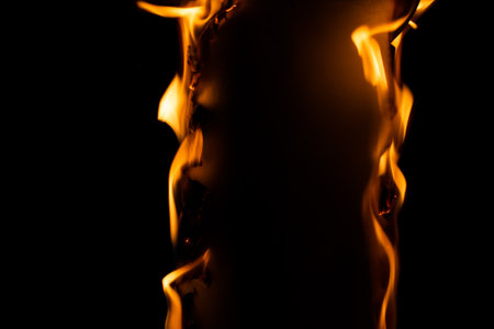 burning paper, glowing edge of paper on a black backgroundの写真素材