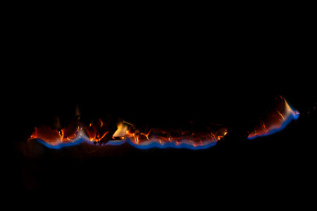 burning paper, glowing edge of paper on a black background