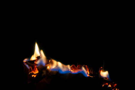 burning paper, glowing edge of paper on a black background