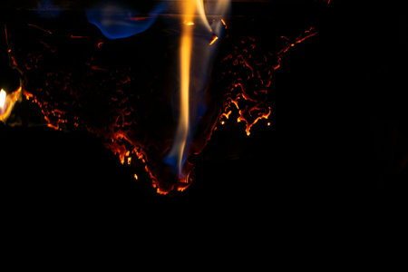 burning paper, glowing edge of paper on a black background