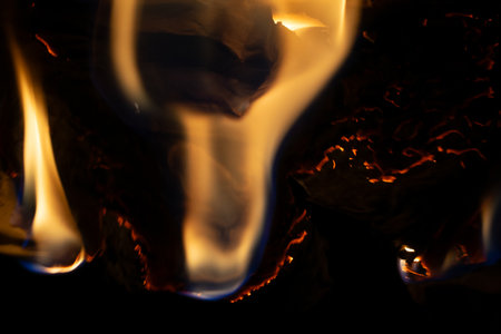 burning paper, glowing edge of paper on a black background