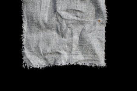 torn old white rag on a black background
