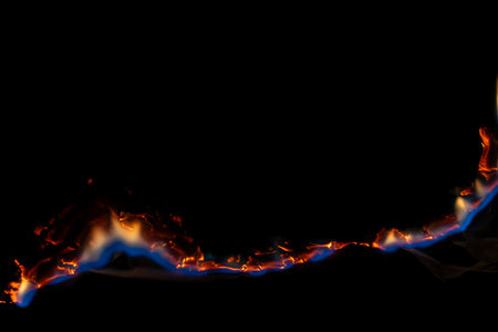burning paper, glowing edge of paper on a black background
