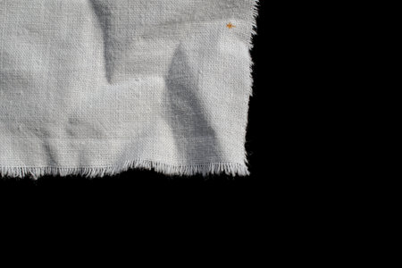 torn old white rag on a black background