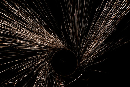 sparks from the grinder glowing in the darkの写真素材