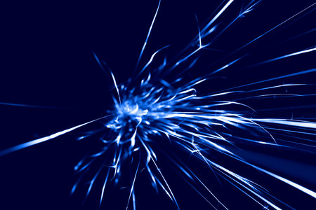blue sparks from the grinder glowing in the dark straight aheadの写真素材