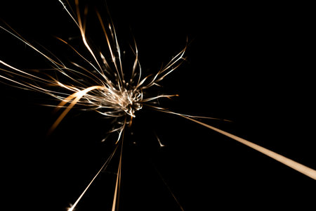 sparks from the grinder glowing in the dark straight aheadの写真素材