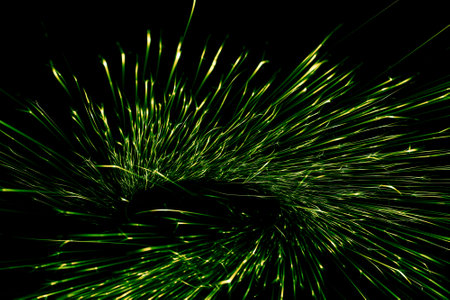 green sparks from the grinder glowing in the darkの写真素材