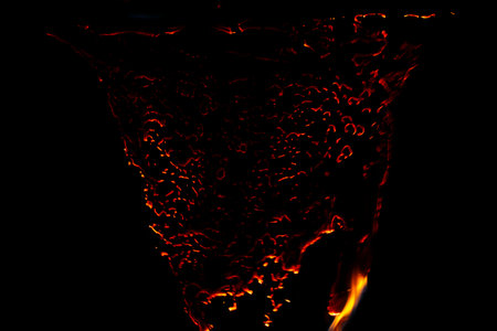 burning paper, glowing edge of paper on a black backgroundの写真素材