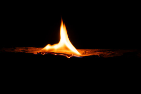 burning paper, glowing edge of paper on a black background