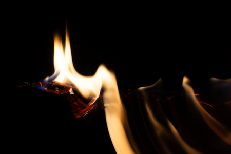 burning paper, glowing edge of paper on a black backgroundの写真素材