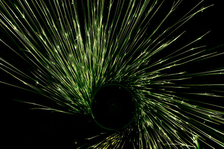 green sparks from the grinder glowing in the darkの写真素材