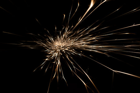 sparks from the grinder glowing in the dark straight aheadの写真素材