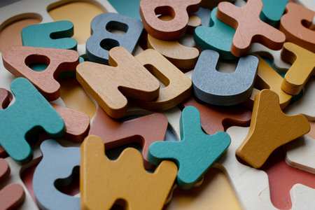 wooden educational letters, scattered letters create a backgroundの写真素材