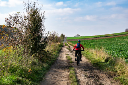 man riding a bicycle on a dirt road