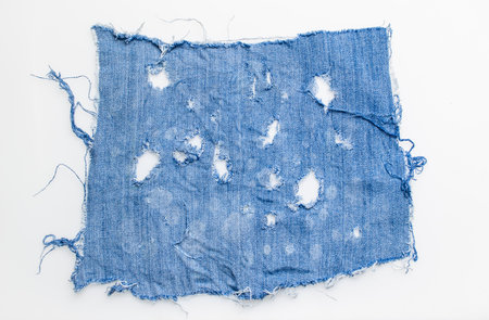 jeans. a frayed and torn piece of denim rag