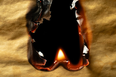 burning old brown paper, glowing edge of paperの写真素材