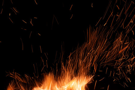 sparks from the fire glowing in the darkの写真素材