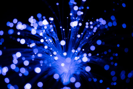 Fiber optical cables glowing blue. bokeh light spotsの写真素材