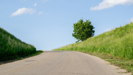 a bend in the road that meets the sky