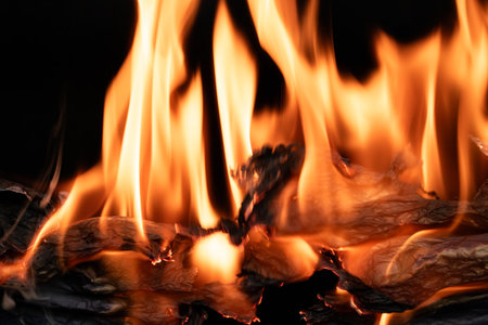 burning paper, glowing edge of paper on a black background