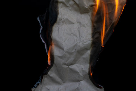 burning paper, glowing edge of paper on a black background