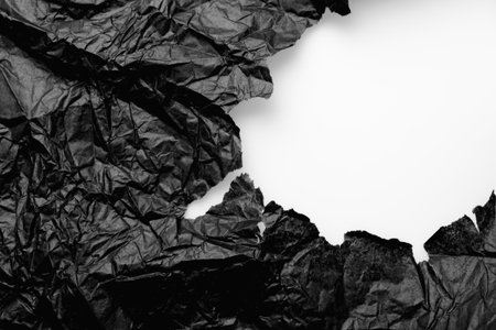 torn black paper on a white backgroundの写真素材