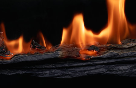 burning paper, glowing edge of paper on a black background
