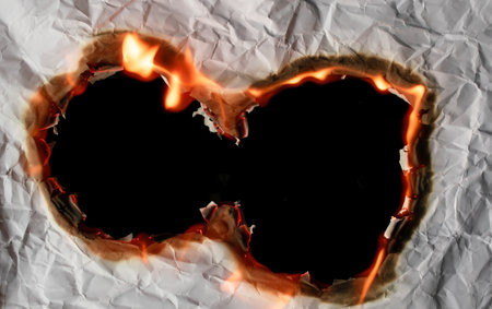 burning paper, glowing edge of paper on a black background