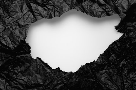 torn black paper on a white backgroundの写真素材