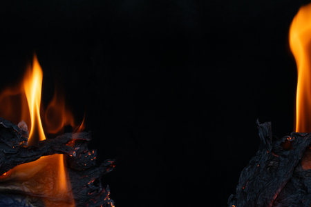 burning paper, glowing edge of paper on a black background