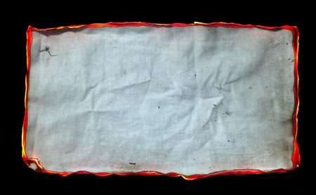 burning paper, glowing edge of paper on a black backgroundの写真素材