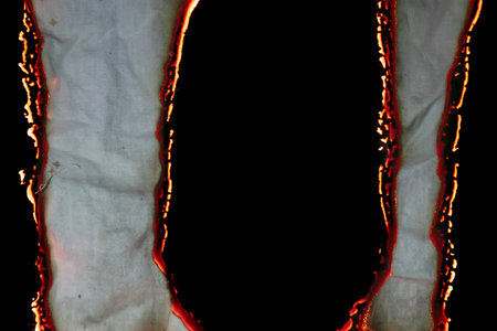 burning paper, glowing edge of paper on a black background.