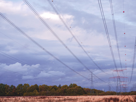 One high-voltage line above a field, before the storm