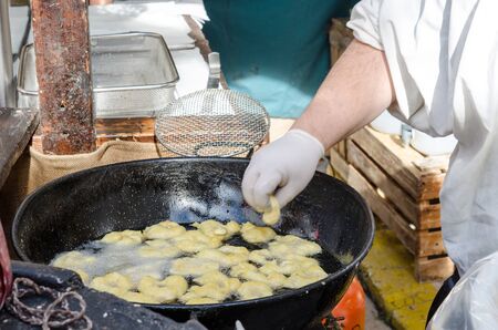 Preparacion deep fried fritters donuts in market, Spainの写真素材