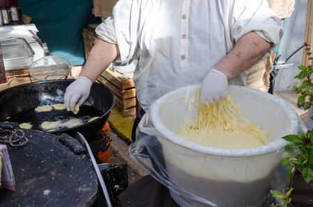 Preparacion deep fried fritters donuts in market, Spainの写真素材
