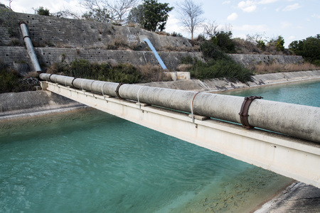 Pipes above the water channel in the Spainの写真素材