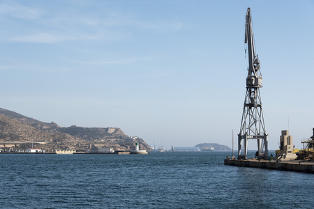 Container cranes loading a ship in the port of Cartagenaの写真素材
