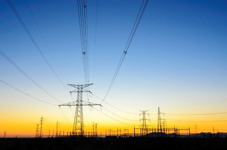 Electric power lines over sunrise , in Spain