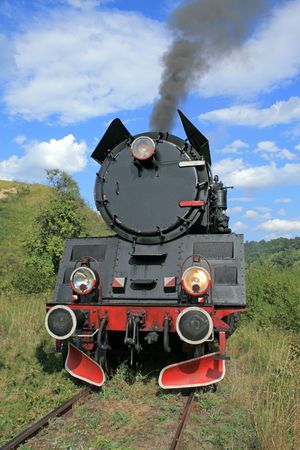 Old retro steam train passing through polish countryside