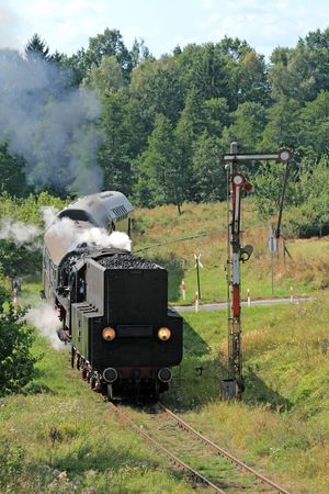 Old retro steam train passing through polish countryside