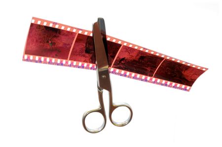 Metal scissors cuts the 35mm negative film stripeの写真素材