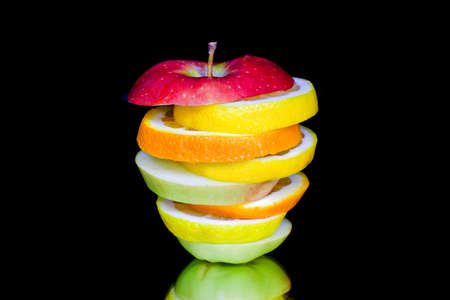 Orange lemon and apple slices composition isolated on black backgroundの写真素材