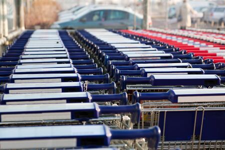 Row of empty shopping carts at the supermarketの写真素材