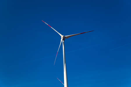 Wind turbine and against blue skyの写真素材