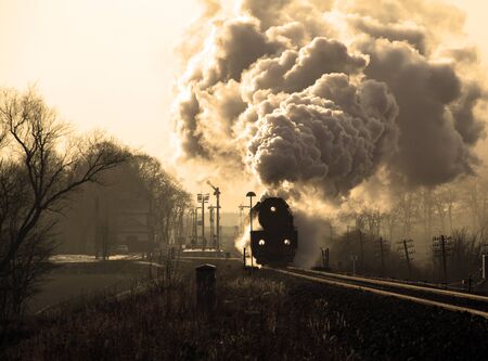 Vintage steam train starting from the station, wintertime